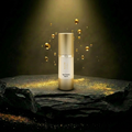 AITHER Age Defying Serum on luxury rock pedestal with golden droplets