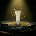 AITHER Hydrating Facial Cleanser on luxury rock pedestal with golden droplets